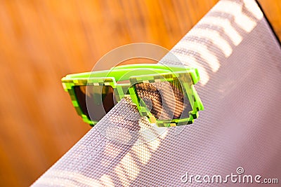 Green thug life pixel model sunglasses shoot outside in a sunny day closeup. Selective focus Stock Photo