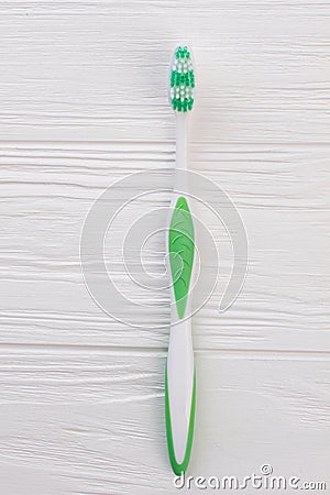 Green tooth brush on white wooden background. Stock Photo