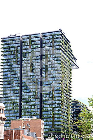 Green tower block in Sydney Australia covered in foliage. Editorial Stock Photo