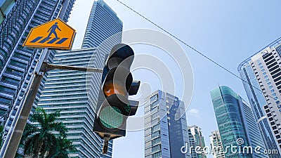 Green traffic light in the city with yellow cross walk street sign and urban cityscape in background. Editorial Stock Photo
