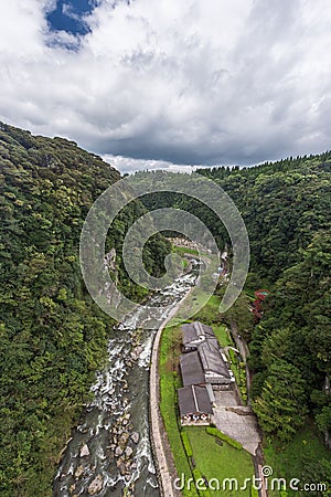 Green valley and japanese house in Kamikawa Otaki Waterfall Park Stock Photo