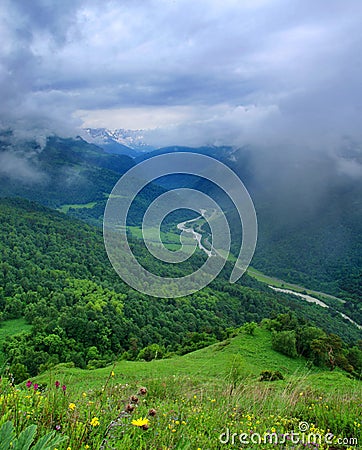 Green valley with a meandering road and river. Stock Photo