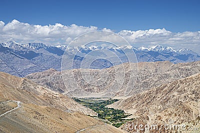 Green valley and winding road in Himalayas aerial view Stock Photo