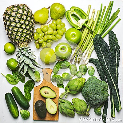 Green vegetables and fruits on a white background. Fresh organic produce Stock Photo