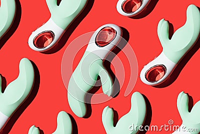 green vibrators pattern for masturbation on a red background Stock Photo