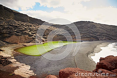 Green volcanic lake Charco de los Clicos at Lanzarote Stock Photo