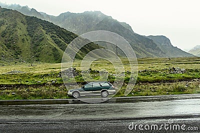 Green wagon Subaru Outback BH stopped on a mountain Editorial Stock Photo