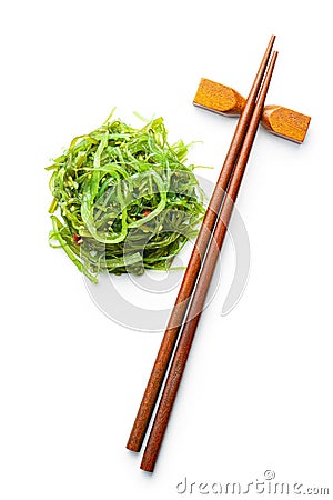 Green wakame. Seaweed salad and chopsticks isolated on white background Stock Photo