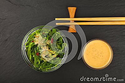 Green wakame seaweed salad with satay sauce Stock Photo