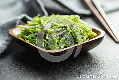 Green wakame. Seaweed salad in wooden bowl Stock Photo
