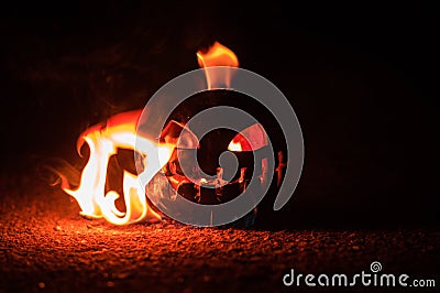 Green watermelon burns with fiery flame on the scary holiday halloween Stock Photo