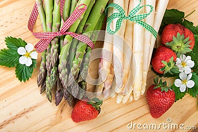 Green and white asparagus over wood, top view. Vegan food, vegetarian and healthy cooking concept Stock Photo