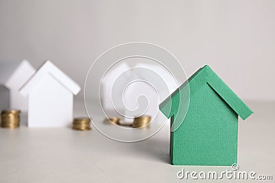 Green and white house models with money Stock Photo