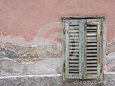 Green window shutter on the facade of an old house Stock Photo