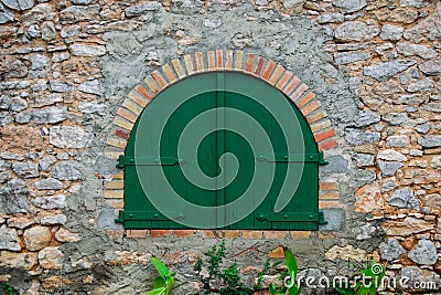 Green wooden door in the old Spanish rural house Stock Photo