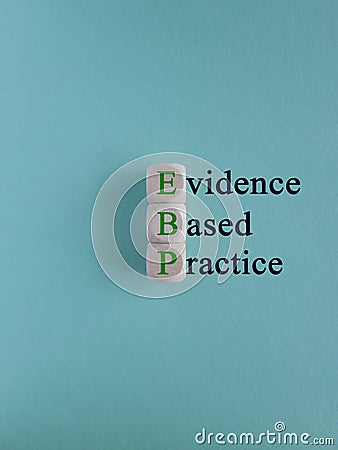 Green words EBP Evidence-based practice concept on wooden cubes. Beautiful blue background. Stock Photo