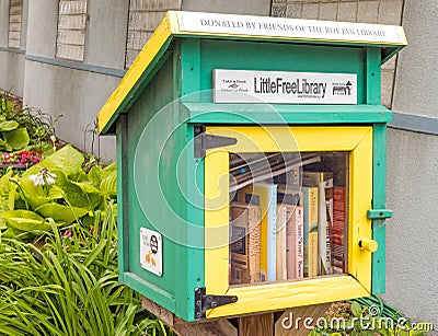Green and yellow little free library and books Editorial Stock Photo