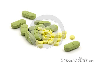 Green and yellow pills Stock Photo