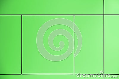 Greenery. Green background crossed by lines forming squares and rectangles in an abstract architectural wall. Stock Photo