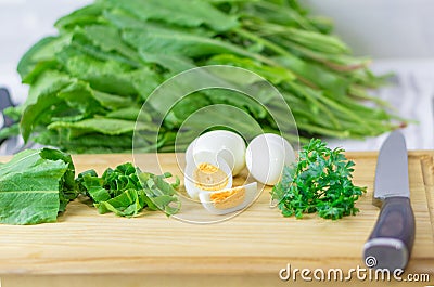 greens and eggs for making sorrel soup Stock Photo