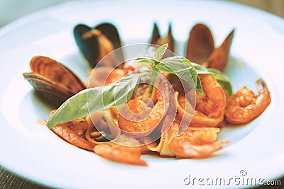 Tasty-looking Italian pasta with shrimps and oysters with shells Stock Photo