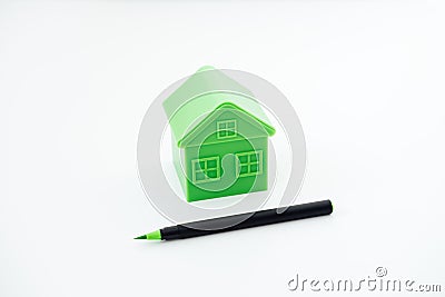 Greenwashing concept with green and black pen and plastic house. Greenwashing marketing ploy products seem more Stock Photo
