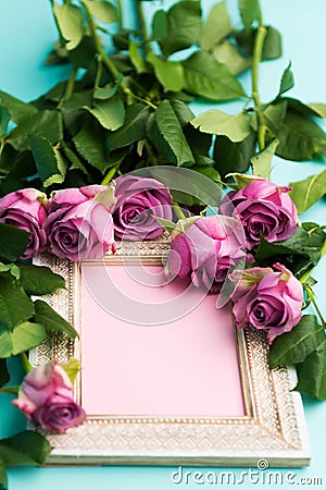 Greeting card with beautiful wooden vintage picture frame, fresh pink roses and copy space. Stock Photo