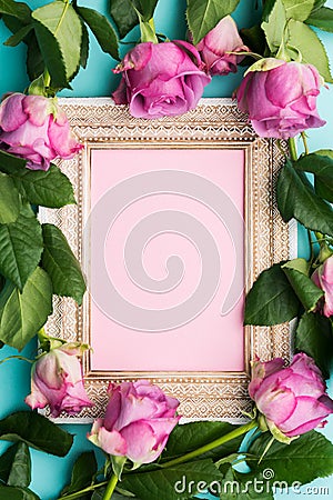 Greeting card with beautiful wooden vintage picture frame, fresh pink roses and copy space. Stock Photo