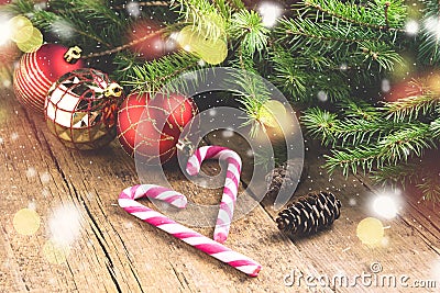 Greeting Card for the Christmas holidays Spruce branches Cones Candy Cane Christmas toys Wooden background Christmas background Li Stock Photo