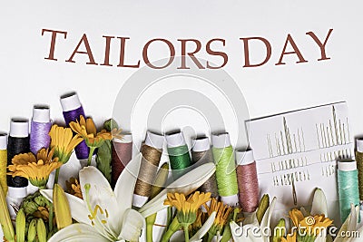 Greeting card with multi-colored threads and the text Tailors Day. For the holiday of a seamstress, tailor, atelier Stock Photo