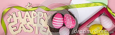 greeting card with text happy easter. multicolored easter eggs on pink background Stock Photo