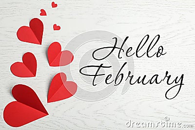 Greeting card with text Hello February. Red paper hearts on white wooden background, flat lay Stock Photo