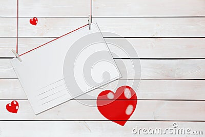 Greeting paper card and three red hearts on wooden white background with copy space Stock Photo