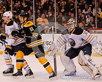 Gregory Campbell screens Ryan Miller. Editorial Stock Photo