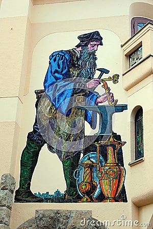 Greiz, Germany - March 21, 2023: Mosaic of a goldsmith, a popular motif by the Leipzig artist Mewes on the wall of a building in Editorial Stock Photo