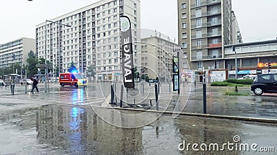 GRENOBLE, FRANCE - JUNE 25, 2023. Emergency vehicle with strobe lights and siren speeding along wet street Editorial Stock Photo