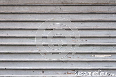 Grey aluminum automatic garage shutter closeup, steel striped sliding door, texture and pattern, old and weathered surface, dirty Stock Photo