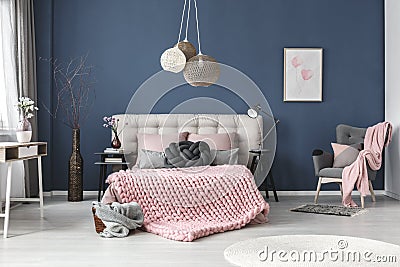 Grey armchair with pink blanket Stock Photo