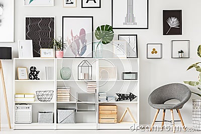 Grey armchair and shelf Stock Photo