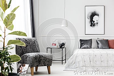 Grey armchair in bedroom Stock Photo