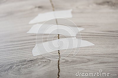 Grey background of broken plywood board with texture sealed with tape Stock Photo