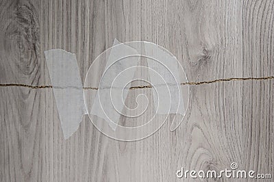 Grey background of broken plywood board with texture sealed with tape Stock Photo