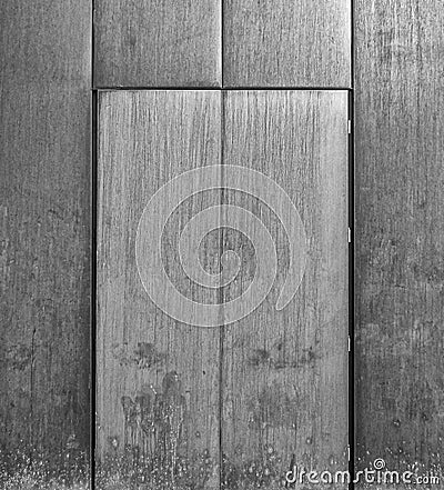 Grey brushed steel door set in a metal wall Stock Photo