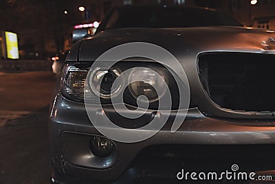 Grey car with broken headlight and radiator grille. Stock Photo