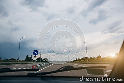 Grey clouds and sky from the driver`s view. Windscreen wipers. Travel lifestyle concept Stock Photo