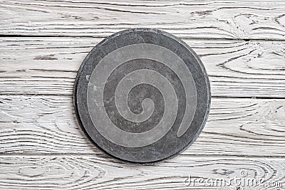 Grey concrete round signboard on light wooden background Stock Photo