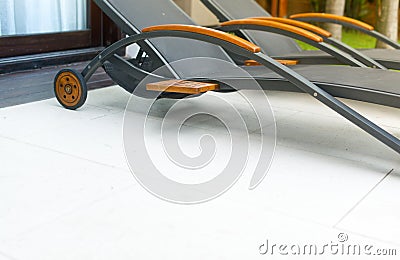 Grey empty chaise lounges in hotel area. Stock Photo