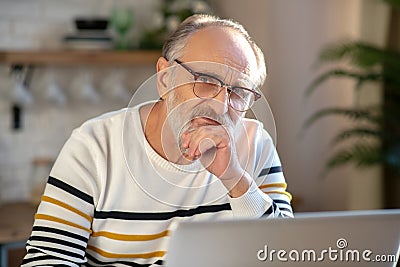 Grey-haired bearded senior man eyeglasses looking tired Stock Photo