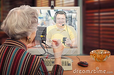 Grey haired woman learning computer peripherals Stock Photo