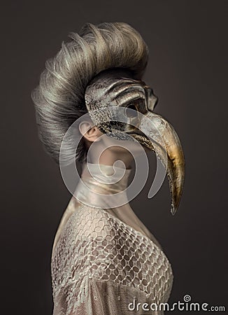 Grey haired woman in white dress and venetian mask Stock Photo